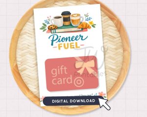 A white card featuring illustrations of coffee, a cookie, a croissant, and books, with the text "Pioneer -FUEL-", a pink "gift card" graphic, and a "DIGITAL DOWNLOAD" banner with a mouse cursor, is displayed on a woven wooden tray.