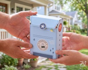 Two pairs of hands hold a light blue box shaped like a mailbox, decorated with stars, a circular "PIONEER SERVICE SCHOOL" emblem, and text reading "May Jehovah Bless Your Ministry!".