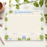 A "Personal Study Planner" notepad, decorated with butterflies and plants, displays a weekly schedule from Monday to Sunday, along with sections for "Spiritual Goals" and "To Pray About," surrounded by a pink mug, pen, paper clips, and a green plant.