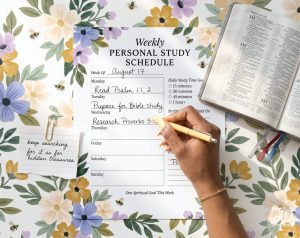 A hand writes on a "Weekly Personal Study Schedule" for "August 17" with tasks such as "Read Psalm 1:1, 2" and "Prepare for Bible study," next to an open Bible and a sticky note reading "keep searching for it as for hidden treasures," all on a floral background.